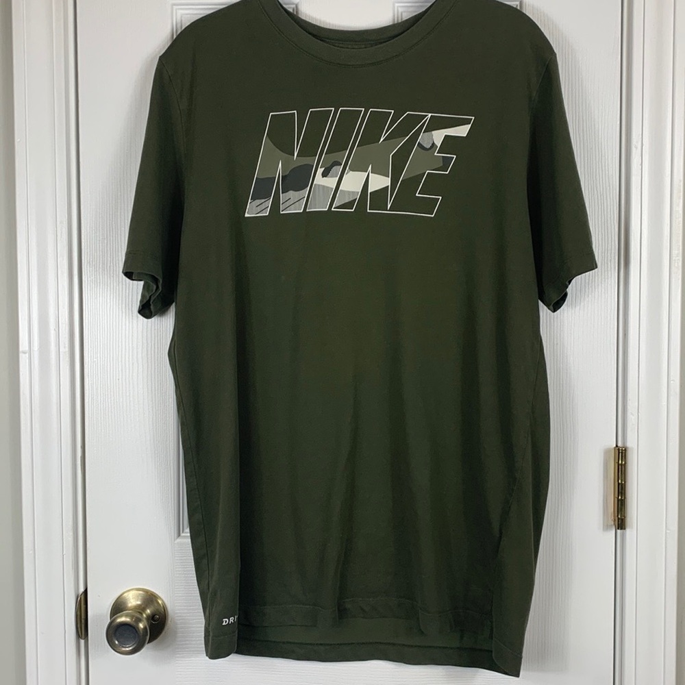The Nike Tee army green shirt size medium with short sleeves. Camouflaged letter